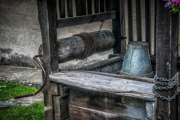 A metal bucket and other details of an old well