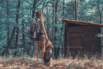 woman walks in the woods with backpack