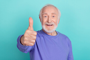 Photo of satisfied cheerful aged man arm finger demonstrate thumb up rate quality isolated on teal color background