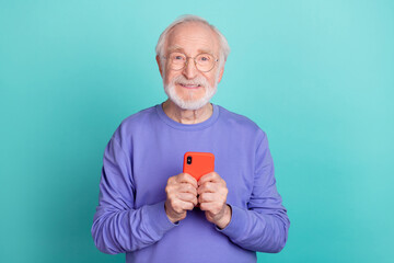 Photo of cheerful friendly man hands hold telephone toothy smile isolated on turquoise color background