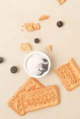 Yogurt, berries, cookies in a kitchen top 