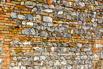 Detail of bricks and stones medieval wall in the city of San Gemignano, Tuscany, Italy, Patterned.