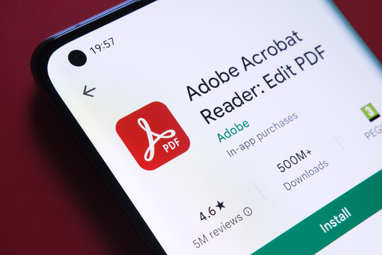 adobe acrobat PDF app seen in Google Play Store on the smartphone screen placed on red background. Close up photo with selective focus. Stafford, United Kingdom, August 2, 2022.