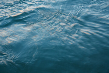 Abstract background: the blue sea lit by the evening sun