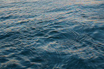 Abstract background: the blue sea lit by the evening sun