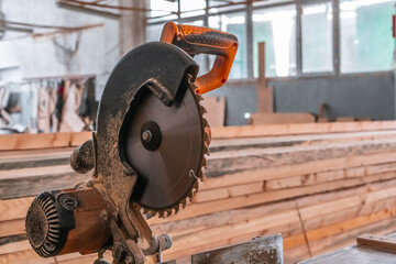 Sawing machine for wood in the workshop for the production of furniture. Woodworking circular saw and wooden bar for cutting.