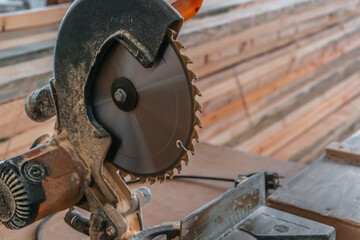 Sawing machine for wood in the workshop for the production of furniture. Woodworking circular saw and wooden bar for cutting.