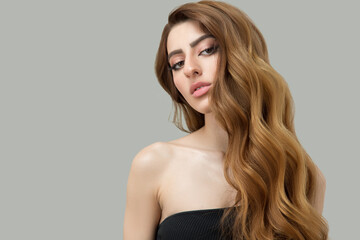 Portrait of a beautiful brunette with long wavy hair. Copycpase