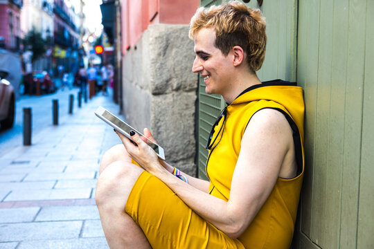 Non binary male using tablet