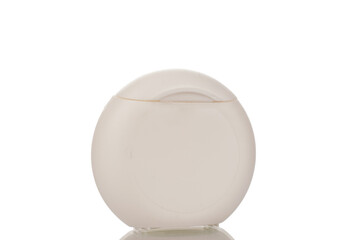 One white plastic package with dental floss, close-up, isolated on white background.