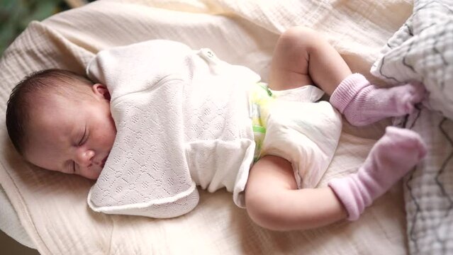 little girl newborn sleeping. portrait a baby close-up sleeping in bed indoors. maternity hospital continuation of the family concept. newborn baby sleeping face lifestyle cute portrait