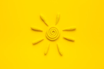 Weather forecast concept with plasticine sun, top view