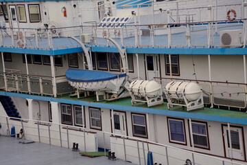 Three decks of cruise ship. There is lifeboat on middle