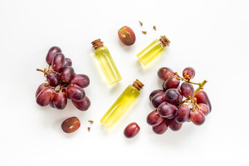 Grape seed oil in bottles with bunch of grapes. Eco cosmetic product