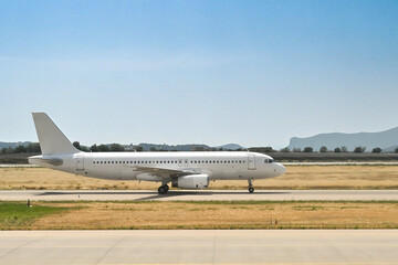 Fototapeta na wymiar Unmarked passenger jet taxiing for take-off at an airport. No people.