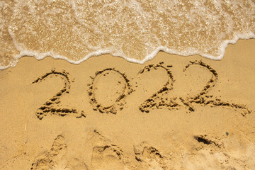 2022 sign in the sand on the beach