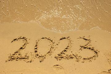 2023 sign in the sand on the beach