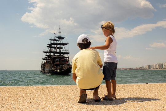 Child, visiting Thessaloniki during the summer with his pet dog and family