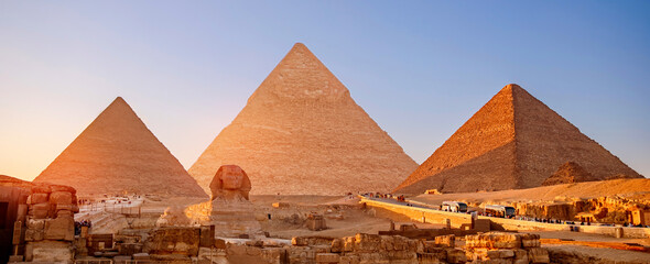 Banner view of famous wonder of world Sphinx and pyramids Giza, Egypt sunset - obrazy, fototapety, plakaty