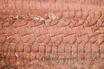 tire mark on wet red earth, Tyre track on dirt mud, retro tone, grunge tone, off road track.                         