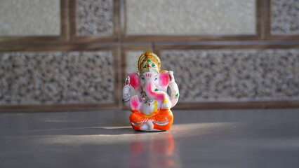 Beautiful Ganesha idol against decorative background. Clear space for text on the poster or greeting card for Ganesh Festival.