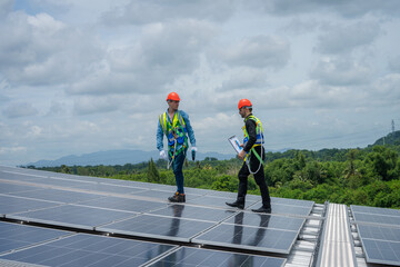 Engineers checking the operation of the system solar cell on an building in an residential area,Photovoltaic module idea for clean energy production.