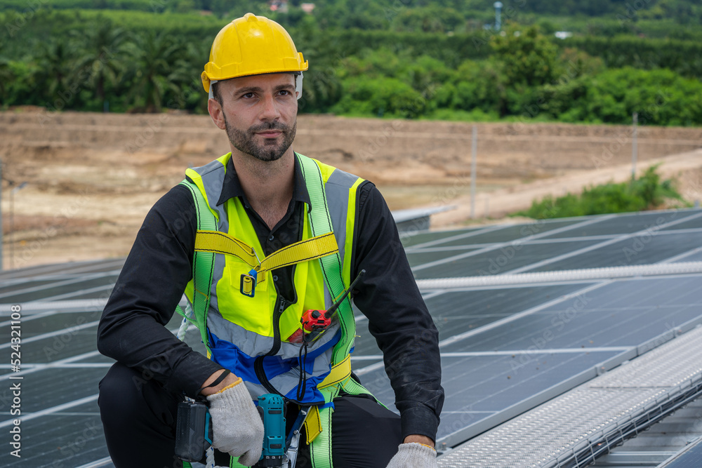 Aufkleber professional worker using drill installing solar panels on the roof of a factory,alternative energy 
