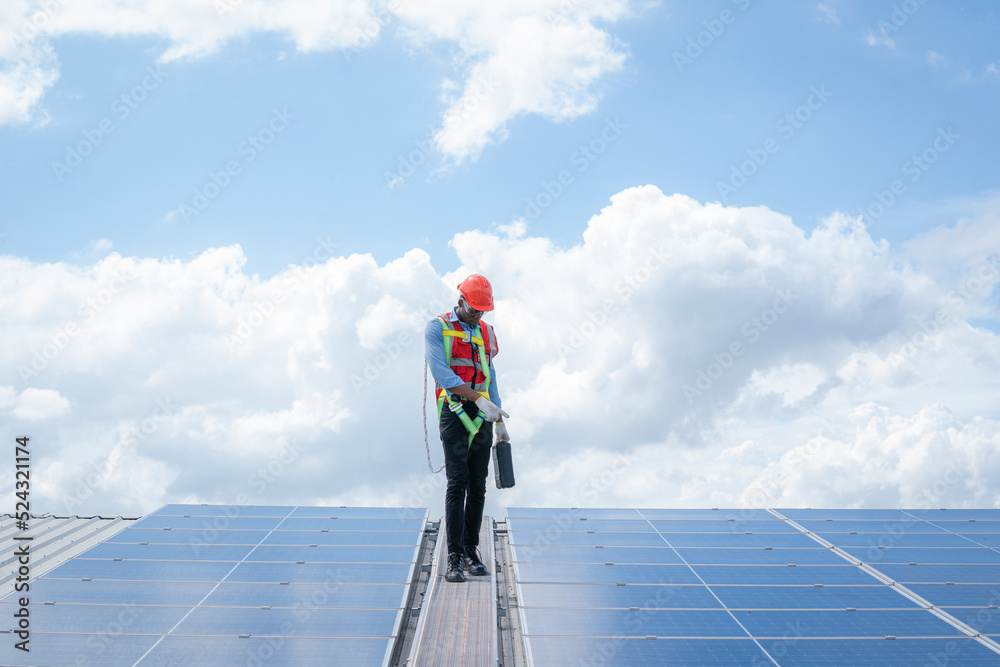 Aufkleber Professional worker installing and checking solar panels on the roof of a factory,Innovative solution for energy solving. Use renewable resources. Green energy.