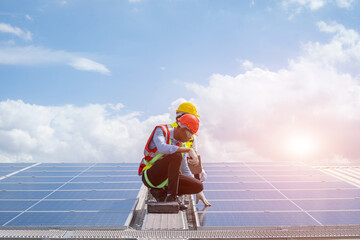 Solar panel technician with drill installing solar panels on roof factory,Sun energy,Solar panel.