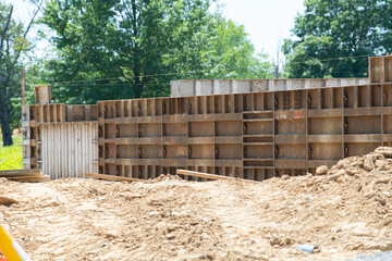 Fototapeta na wymiar Concrete foundation with reinforcement and metal slab construction site, process of house building formwork