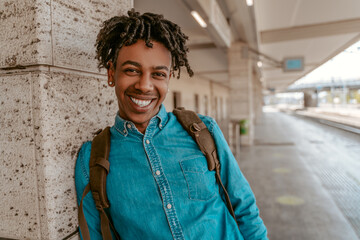 African guy smiling at camera on train station