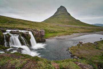 Morning at The lower falls of Kirkjufellsfoss (waterfall) with Kirkjufell, Grundarfjörður, Snaefellsnes peninsula, Iceland.