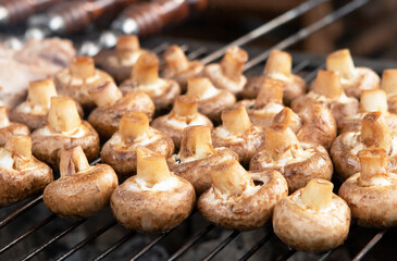 cooking champignon mushrooms on the grill in summer