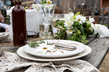set table at a rural wedding. cutlery, plates and glasses