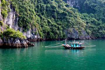 Naklejka na ściany i meble Fishing boat in Ha Long Bay