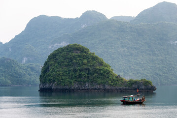 Fishing boat against whale shaped island