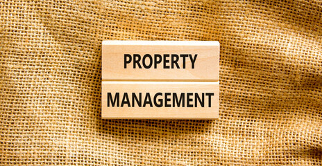 Property management symbol. Concept words Property management on wooden blocks on a beautiful canvas table canvas background. Businessman hand. Business property management concept. Copy space.