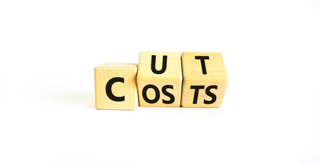 Cut costs symbol. Concept words Cut costs on wooden cubes. Beautiful white table white background. Cut costs and business concept. Copy space.