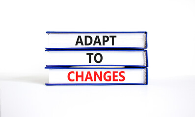 Adapt to changes and support symbol. Concept words Adapt to changes on books. Beautiful white table white background. Business and support Adapt to changes quote concept. Copy space.