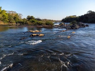 beautiful river with many rocks and green vegetation