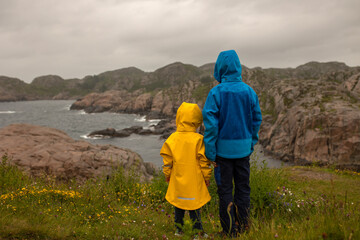 Fototapeta na wymiar Family visiting the Lindesnes Fyr Lighthouse in Norway on a rainy cold day