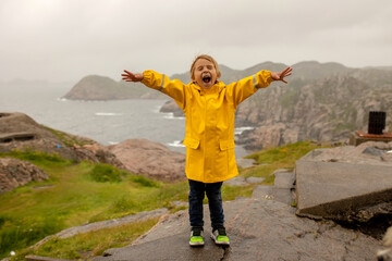 Family visiting the Lindesnes Fyr Lighthouse in Norway on a rainy cold day