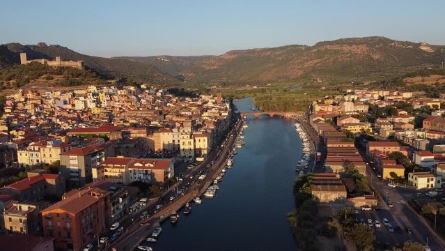 Flying over the Temo river, over the historic center of bosa, towards the castle on the hill