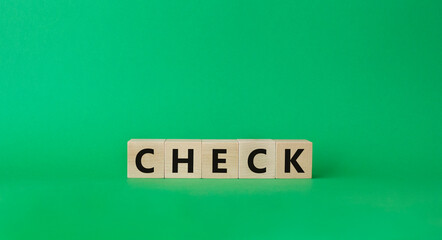 Check symbol. Wooden cubes with words Check. Beautiful green background. Business and Check concept. Copy space.