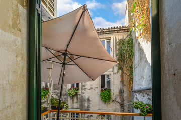 A small balcony terrace inside a historic older building in the medieval and ancient center of...