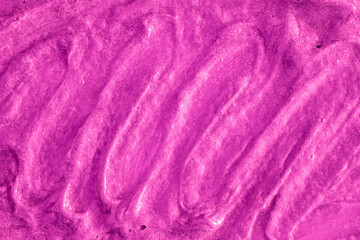 Smears of liquid purple magenta gel texture background. Smeared oil paint with pearly shine. Cream scrub to cleanse the skin of the face and body. Spa treatments, skin care.