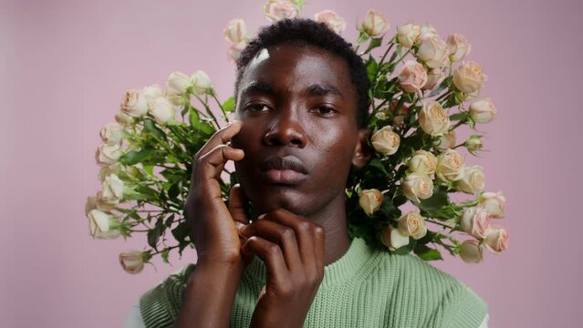Man posing with a bouquet of roses around his face