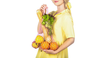 Woman holding eco-friendly string reusable net bag fruits, vegetables. Ingredient in healthy, dietary and vegetarian food. Zero waste concept. Girl holding cotton eco bag organic fruits, vegetables