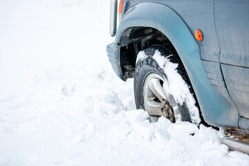 Wheel of a car stuck in the snow. Winter tires. Car tires for snow and ice.