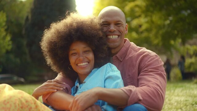 Happy multiethnic beautiful couple in love visiting Paris. Young man and woman on vacation in the french capital city, walking and doing activities around the eiffel tower area	